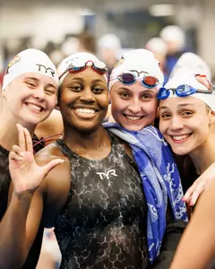 The 800 free relay team celebrates their silver medal