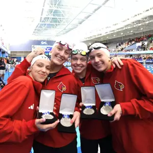 the 200 free relay team shows off their silver medals