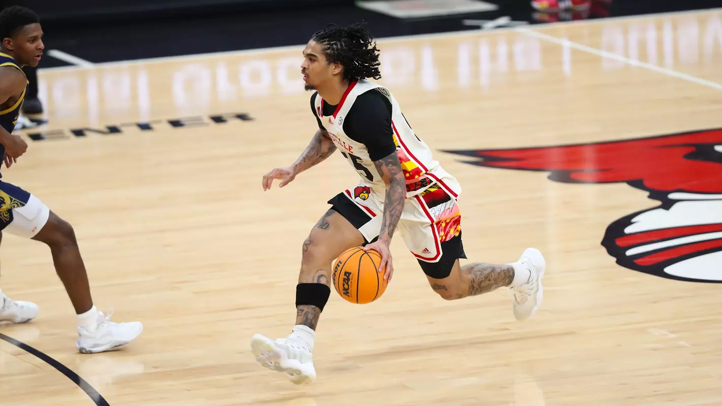 Skyy Clark brings the ball up the court against Notre Dame on Feb. 21, 2024, at the KFC Yum! Center.