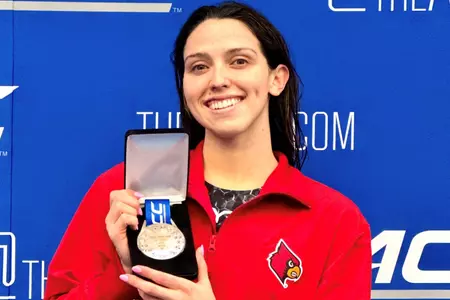 Gabi Albiero shows off her silver medal in the 100 fly