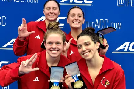 400 medley relay team shows off their medals on the podium