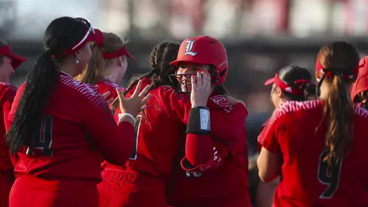 Louisville softball celebrates Gabby Holloway's home run in the 12-4 win over Michigan