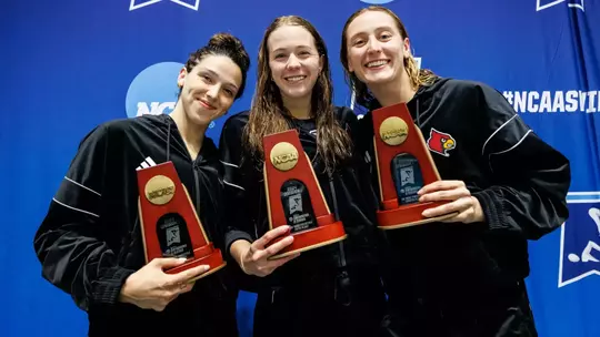 Three Cardinals on the NCAA podium with their trophies for the 50 freestyle