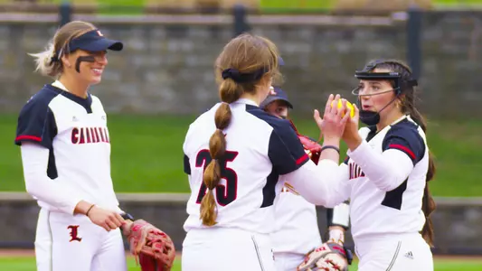 Softball infield huddle vs. Illinois