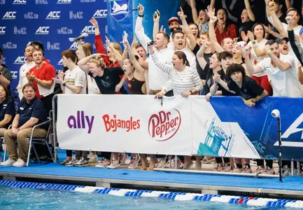 Cardinal swimmers celebrate on deck for the relay
