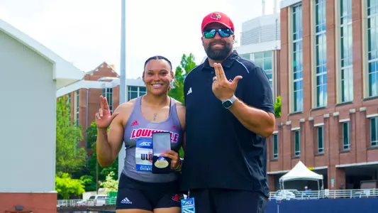 Jayden Ulrich and Cory Martin pose after winning the women's shot put ACC title.