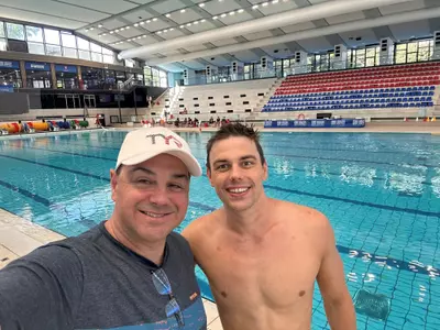 Denis Loktev and Arthur Albiero pose at the Olympic pool
