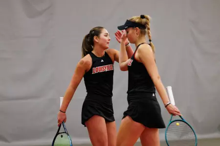 Alice Otis and Elisabeth Iila high five at midcourt
