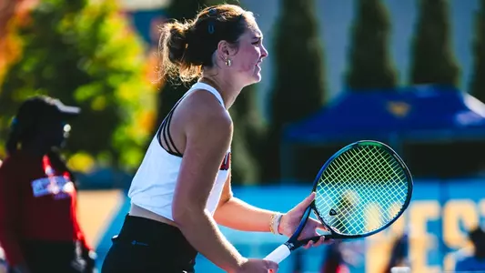 Alice Otis gets down to receive a serve