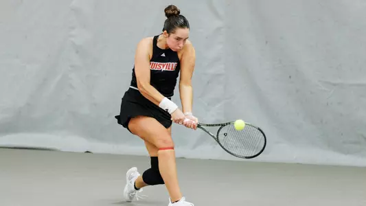 Allie Gretkowski crouches down to hit a backhand