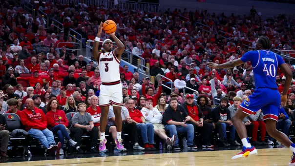Ryan Conwell shooting the ball over a Kansas defender