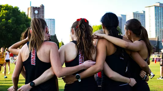 Women's team huddle at the Sean Earl Lakefront Invitational