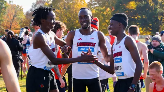 Ian Kibiwot, Elsingi Kipruto and Geoffrey Kirwa celebrate after earning All-ACC honors at the ACC Cross Country Championships.
