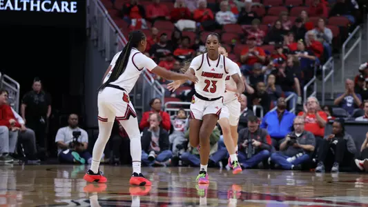 Skylar Jones & Tajianna Roberts high five against Colorado