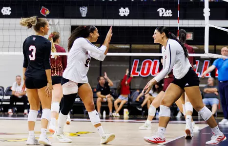 Nayelis Cabello and Hannah Sherman high five after a block