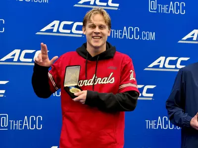 Tommy Bried shows off his gold medal from the 400 IM