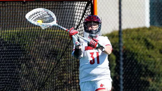 Louisville lacrosse goalie J Pleck with the ball during the game against North Carolina