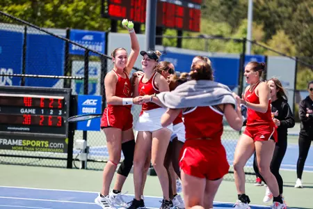 The Cardinals rush the court of Elisabeth Iila after she clinched the match at ACC Championship