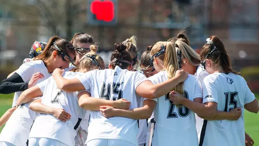 Louisville lacrosse team huddle against Liberty