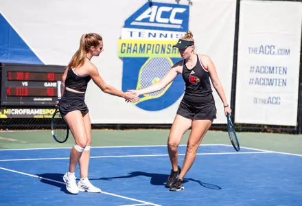 Elena Noguero and Elisabeth Iila high five on the court