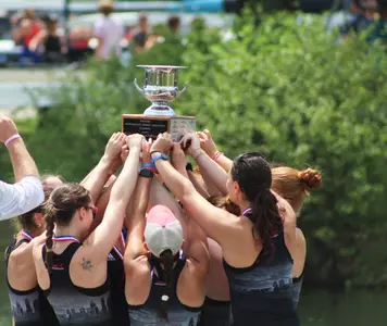 Louisville's Varsity 8 hoists their trophy at the SIRA Championship
