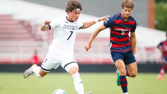 Chase Vazquez dribbling past the defender during the game against Southern Indiana on August 21st.