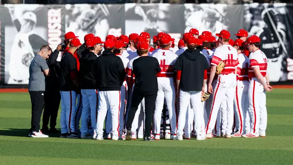 Baseball team huddled in the outfield