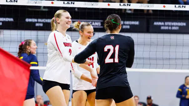 Chloe Meester, Brooke Bultema and Payton Petersen celebrate a point against California