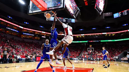 Flory Bidunga dunks over a defender