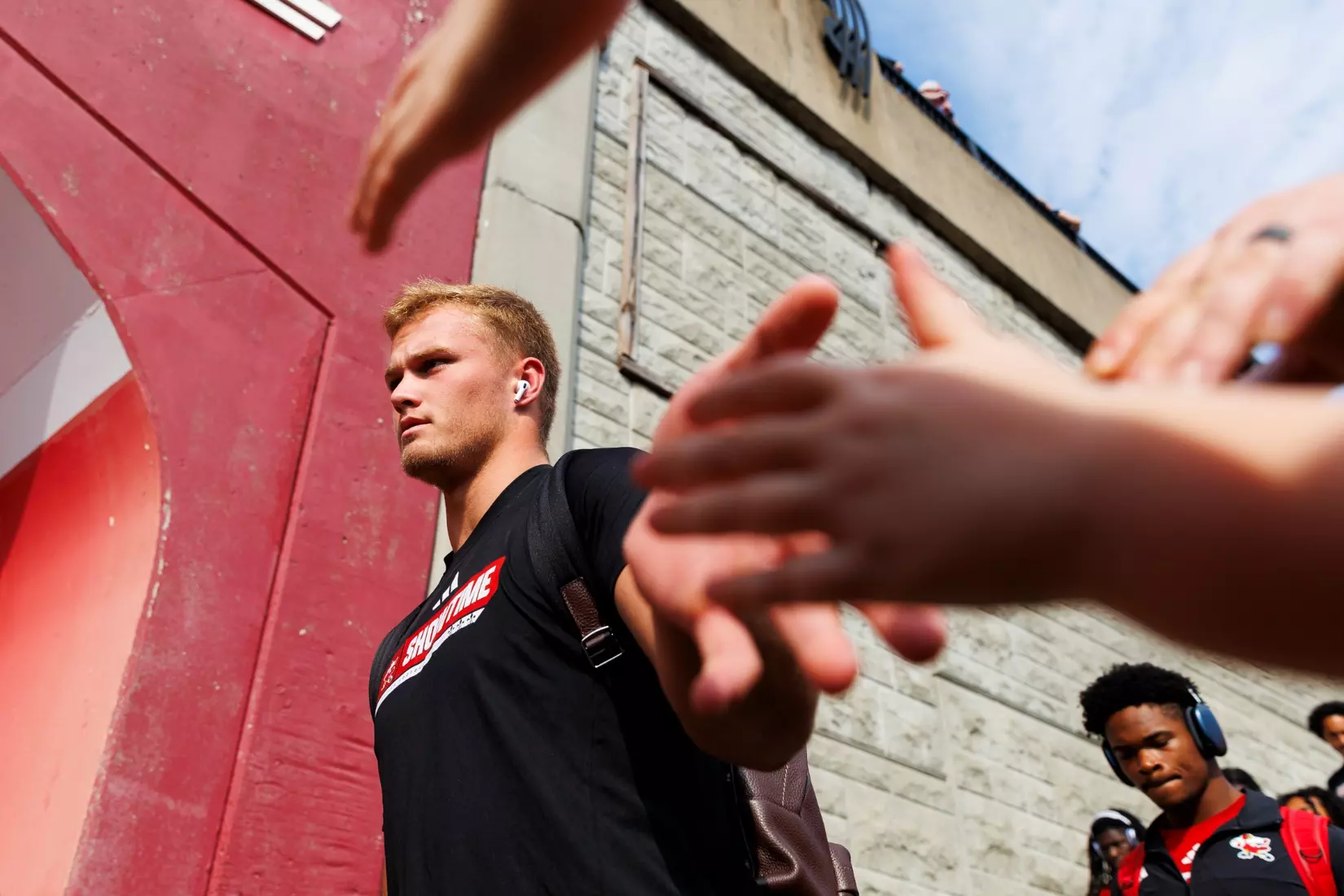 Lincoln Kienholz high-fives fans during the Card March before the game against Villanova at L&N Stadium on September 11.