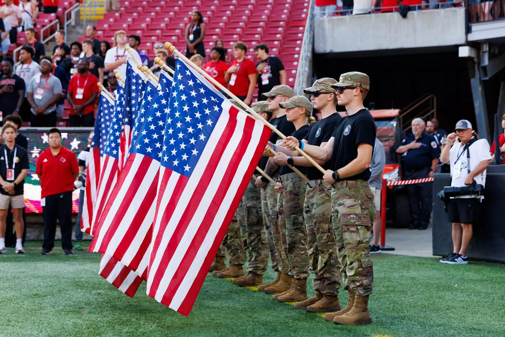 Flags are held in remembrance of 9/11 before the game against Villanova at L&N Stadium on September 11.