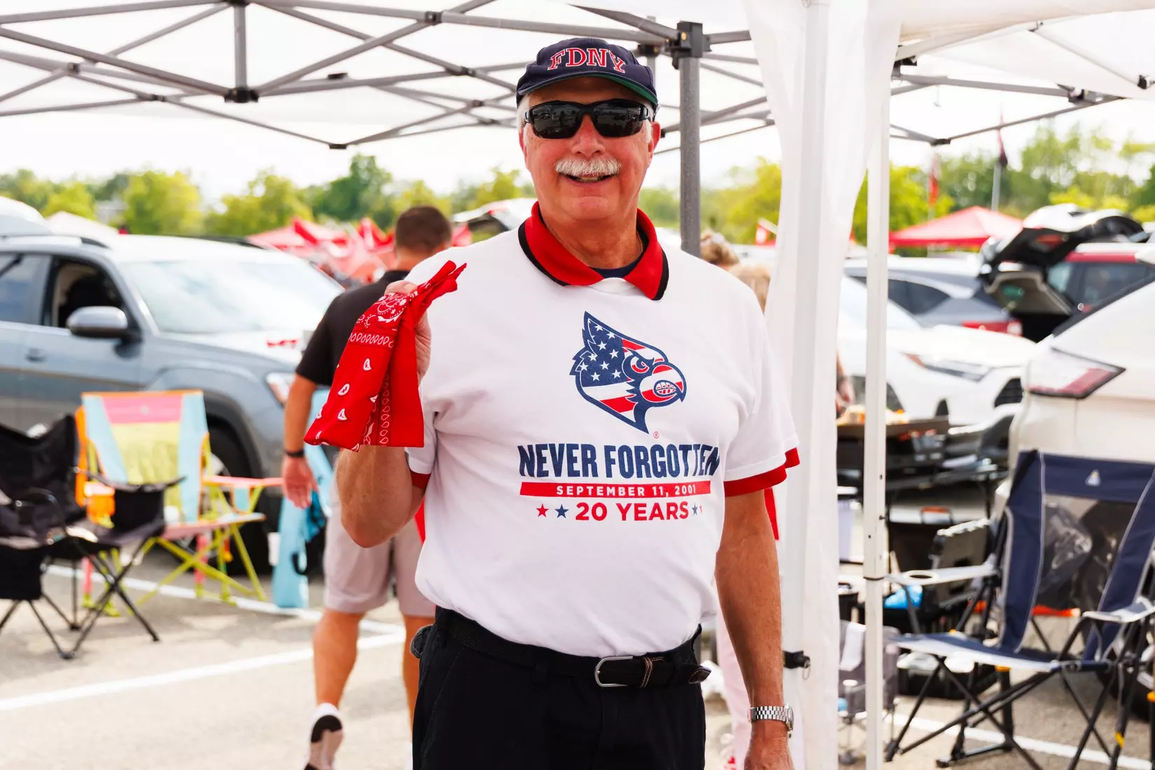 A fan poses with a red bandana in remembrance of 9/11 before the game against Villanova at the L&N Stadium on September 11.