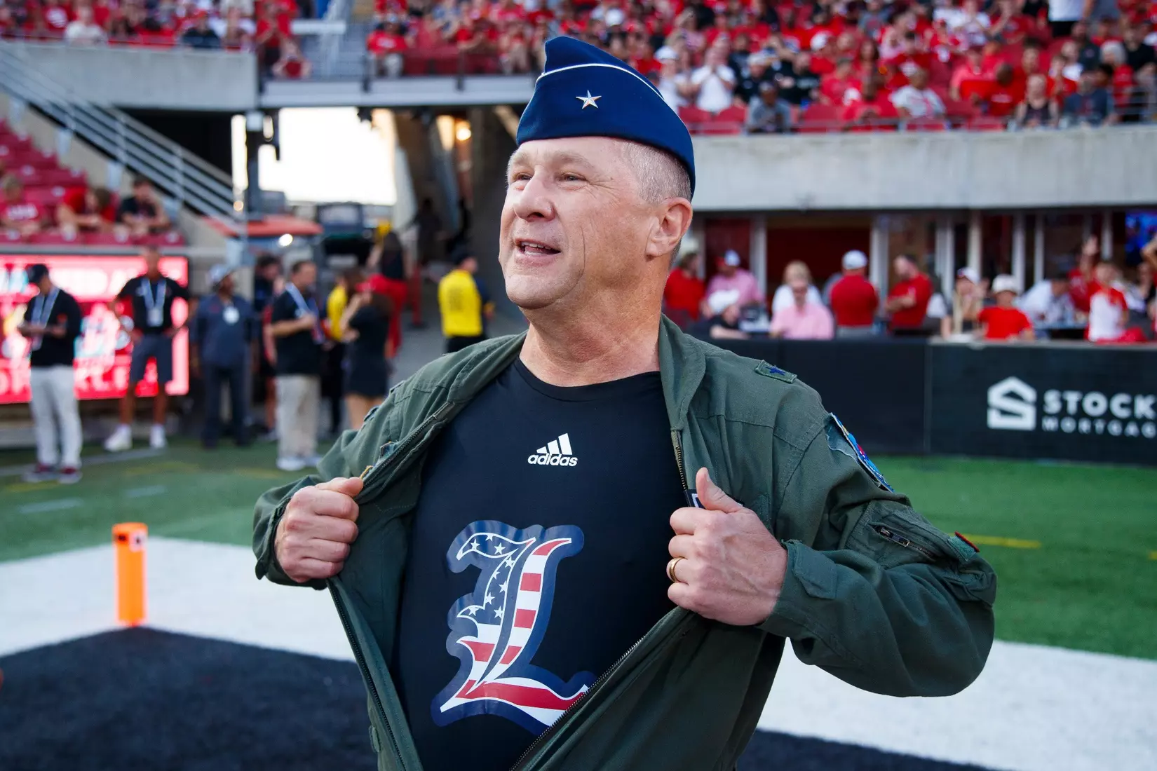 A veteran showing his UofL shirt while being honored in the salute to service tribute during the game against Villanova at L&N Stadium on September 11.