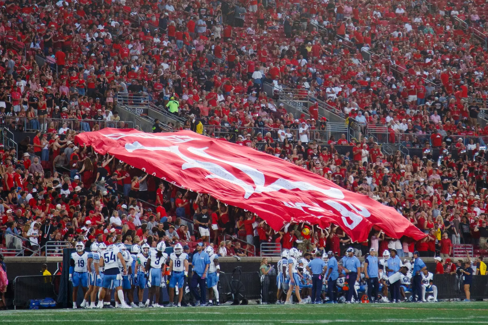 The student section raising a banner during the game against Villanova at L&N Stadium on September 11.
