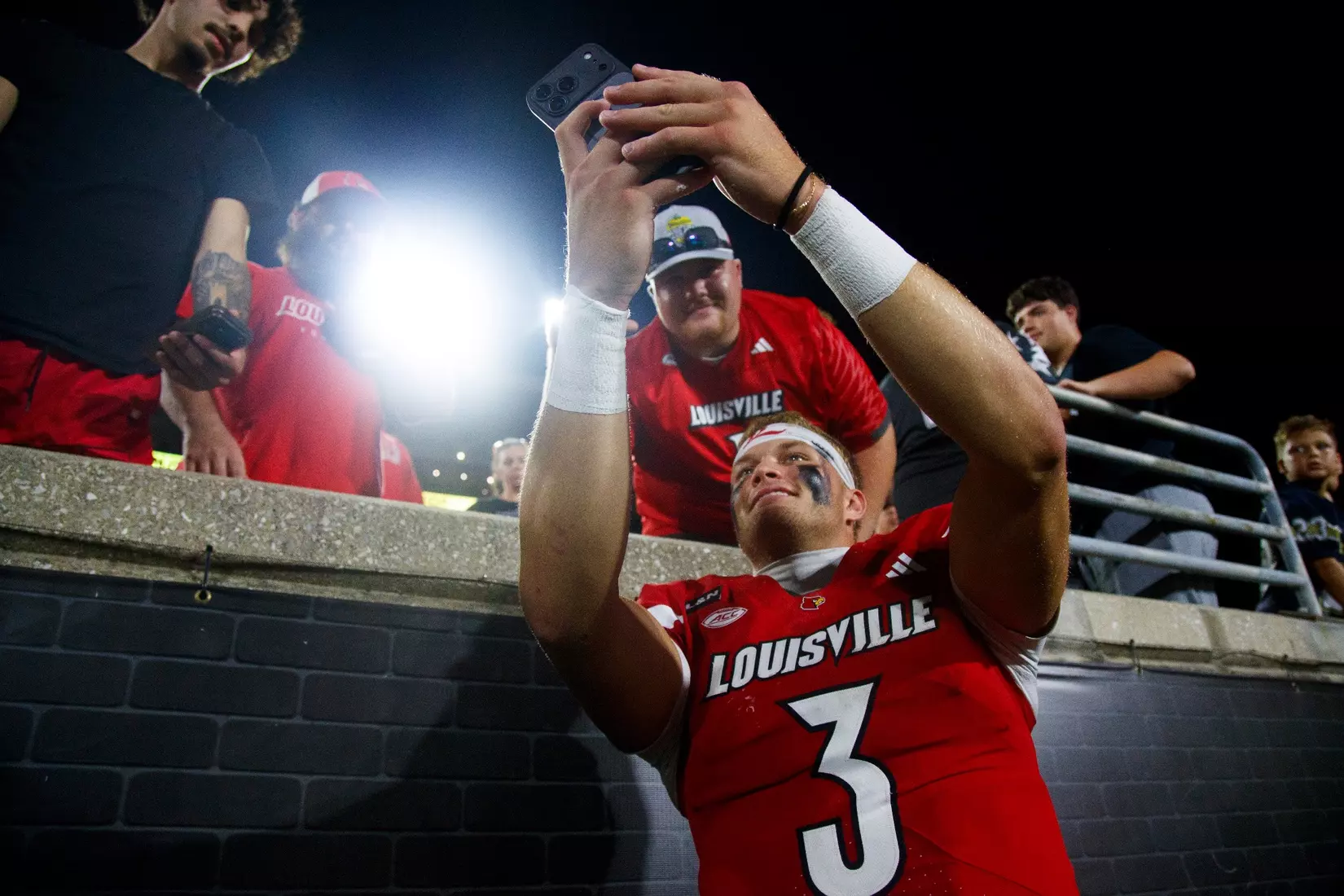 Lincoln Kienholz taking a photo with fans after the game against Villanova at L&N Stadium on September 11.