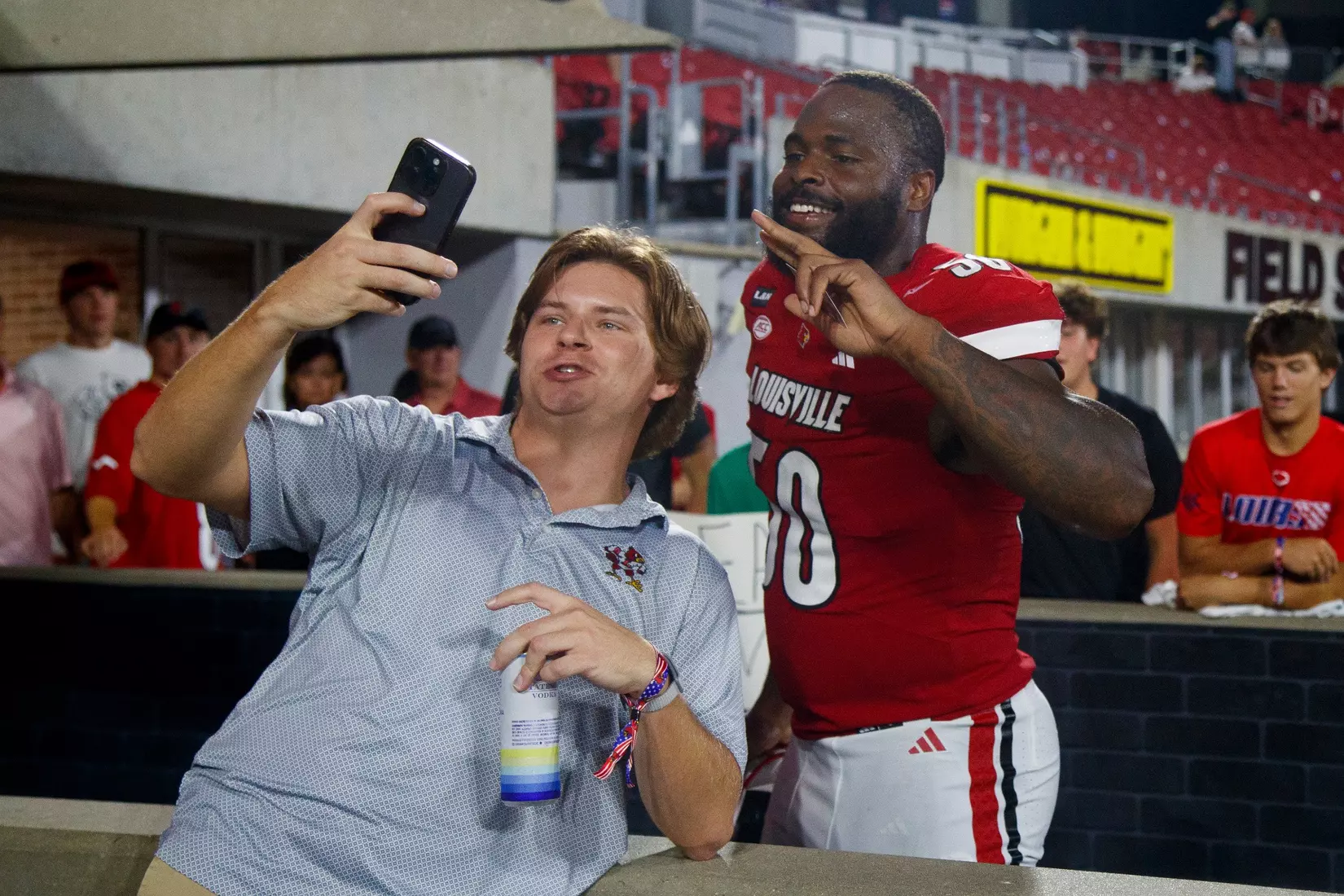 Clev Lubin taking a photo with a fan after the game against Villanova at L&N Stadium on September 11.