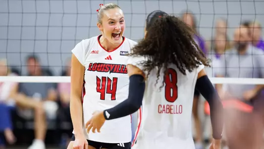 Brooke Bultema and Nayelis Cabello celebrate a point against TCU