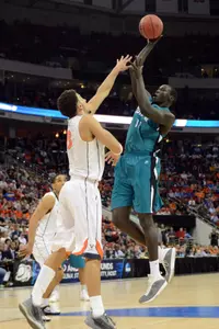 Coastal Carolina Chanticleers center El Hadji Ndieguene shoots the ball over Virginia Cavaliers forward Anthony Gill in the second half.
