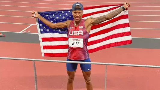 Dallas Wise Holding Up American Flag at Paralympics