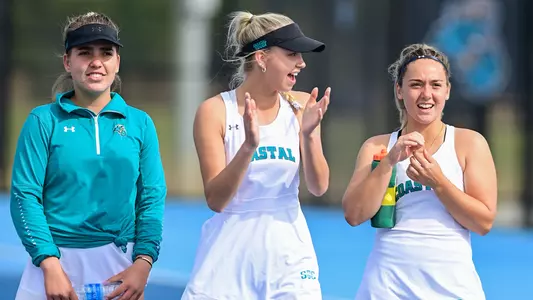 Women's Tennis players cheering on teammates