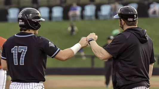 Caden Bodine and Kevin Schnall fist bump versus Davidson