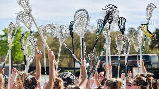 Team holding up sticks