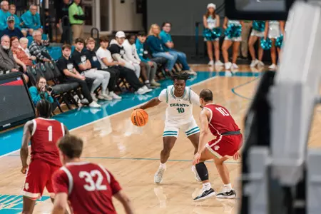 Naz Brown dribbles ball against Southern Virginia on 12/11/2024