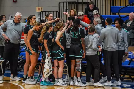 Women's basketball huddles against PC on 12/15/2024