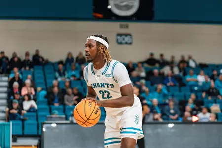 Denzel Hines dribbles ball against Southern Virginia on 12/