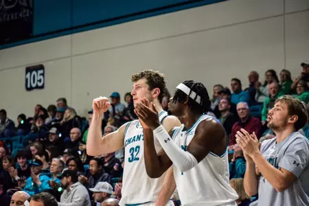 Colin Granger and Andre Mulibea cheer against Marshall on 1/18/2025