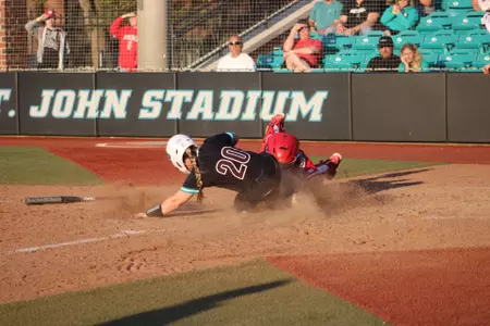 Moira Baxter slides into home against Wisconsin on 3/1/2025