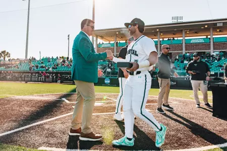 Kevin Schnall congratulates Blake Barthol on baseball opening day