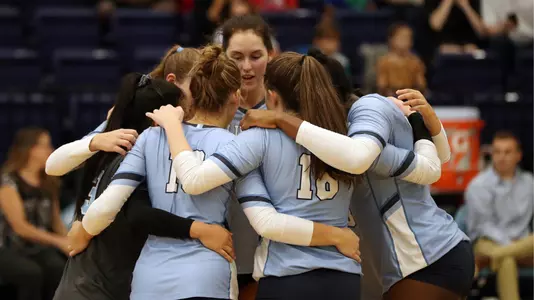 Volleyball team huddle vs Harvard 2018