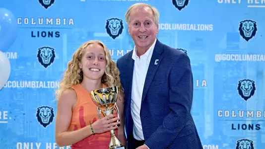 Phoebe Anderson Poses with the Campbell Trophy with Columbia Athletics Director Peter Pilling